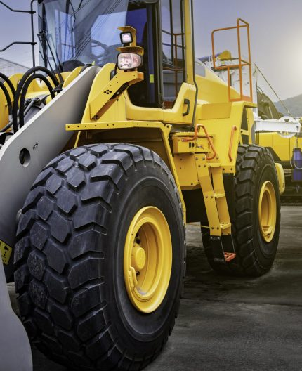 close up of wheel tractor loader. construction machinery heavy equipment. parked at the warehouse.